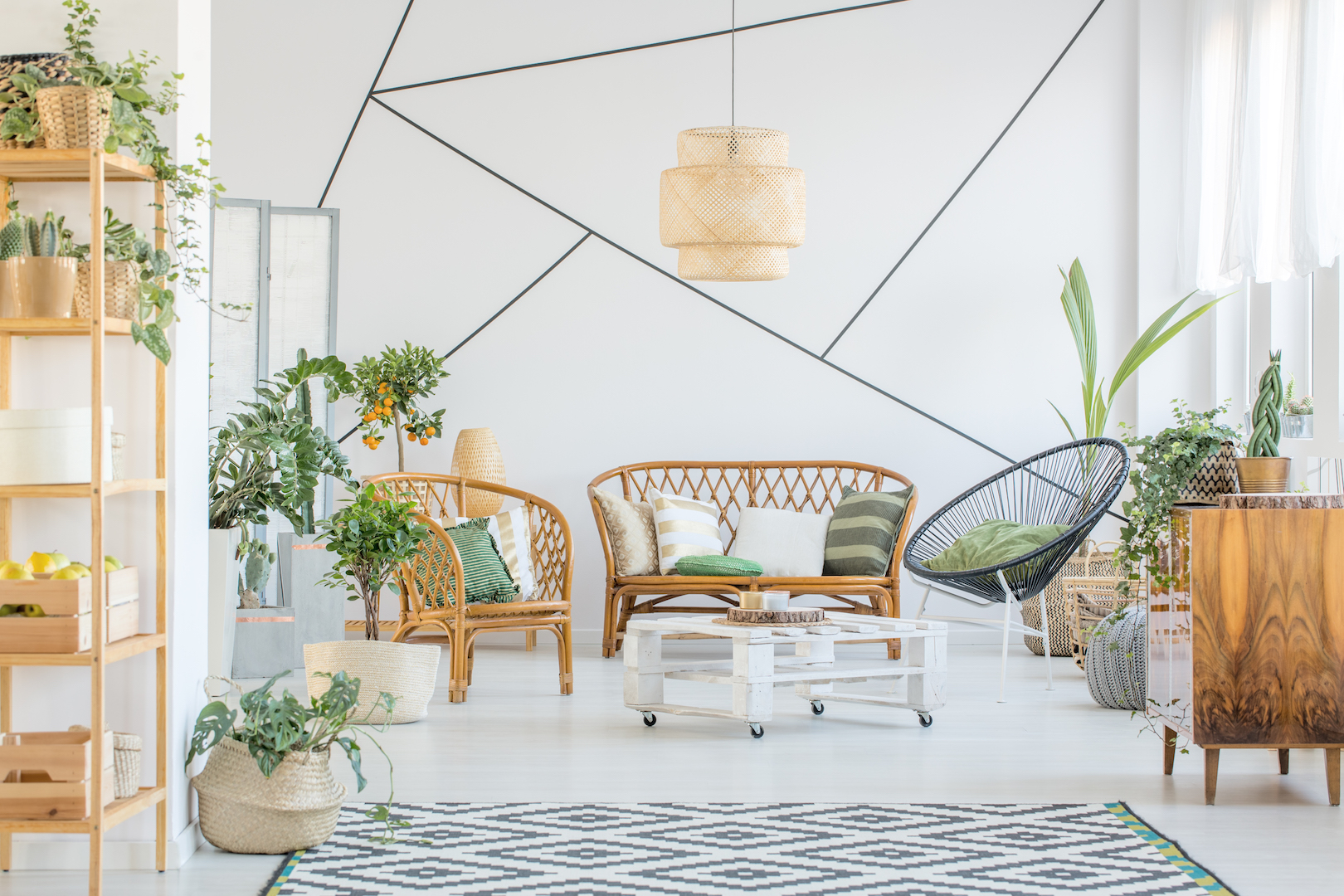 Decorative tape on a wall in white living room with rattan accessories